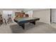 Basement game room with neutral carpet, and ping pong table for entertaining at 11615 E Maplewood Ave, Englewood, CO 80111