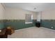 Finished basement room with carpet and half wall with scenic wallpaper border at 11615 E Maplewood Ave, Englewood, CO 80111