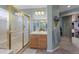 Bathroom with a shower and glass door plus a vanity and large mirror at 11615 E Maplewood Ave, Englewood, CO 80111