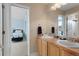 Bathroom with double sinks, and an adjoining bedroom at 11615 E Maplewood Ave, Englewood, CO 80111