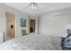 Bright bedroom featuring neutral walls, a ceiling fan, and an ensuite bathroom at 11615 E Maplewood Ave, Englewood, CO 80111