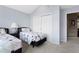 Bedroom featuring two twin beds, blue walls, and large closet at 11615 E Maplewood Ave, Englewood, CO 80111