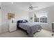 Comfortable bedroom with a large window, neutral walls, and ceiling fan at 11615 E Maplewood Ave, Englewood, CO 80111