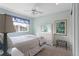 Bedroom with a dresser, a large window, and a bright blue accent wall at 11615 E Maplewood Ave, Englewood, CO 80111