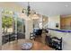Open breakfast nook featuring chandelier, table, chairs and an open view to the living room and bar seating at the kitchen counter at 11615 E Maplewood Ave, Englewood, CO 80111