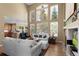 Bright living room with high ceilings, large windows, and comfortable seating at 11615 E Maplewood Ave, Englewood, CO 80111