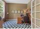 Home office featuring a wood desk, built-in shelving, an accent rug, and a large window for natural light at 11615 E Maplewood Ave, Englewood, CO 80111