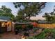 Brick patio with seating area, umbrella, and fire pit at 56 Hillside Dr, Wheat Ridge, CO 80215