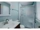 Bathroom featuring blue walls, a glass-enclosed shower, and a modern vanity with a mirror at 11644 Jackson St, Thornton, CO 80233