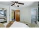 Bedroom with two doorways, a mirrored closet door, and natural light filtering through the window at 11644 Jackson St, Thornton, CO 80233