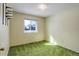 Empty bedroom featuring green carpet, a window providing natural light, and minimalist decor at 11644 Jackson St, Thornton, CO 80233