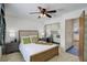 Bedroom featuring mirrored closet doors, a ceiling fan, and a view into an adjacent room at 11644 Jackson St, Thornton, CO 80233