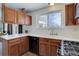 Functional kitchen with wooden cabinets, white countertops, and a gas stove at 11644 Jackson St, Thornton, CO 80233