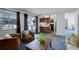 Cozy living room featuring blue carpet, a sliding door leading to the deck, and an open layout to the kitchen at 11644 Jackson St, Thornton, CO 80233