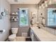 Cozy bathroom featuring white fixtures, gray walls, and decorative shelves near a sunny window at 1539 Bennet Mountain Rd, Castle Rock, CO 80109