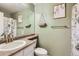 Inviting bathroom featuring a vanity sink, floral shower curtain, and sage green walls at 1539 Bennet Mountain Rd, Castle Rock, CO 80109