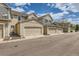 Exterior view of townhomes with garages, painted in neutral tones under a bright sky at 1539 Bennet Mountain Rd, Castle Rock, CO 80109