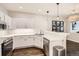 Well-lit kitchen with stainless steel appliances, modern lighting, and white subway tile backsplash at 1539 Bennet Mountain Rd, Castle Rock, CO 80109