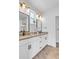 Modern bathroom with double vanity, sleek fixtures, framed mirrors, and neutral-toned countertops at 2108 Alcott Way, Broomfield, CO 80023