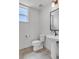 Clean half bathroom has new fixtures including a toilet and stylish pedestal sink at 2108 Alcott Way, Broomfield, CO 80023