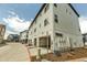 Modern townhome boasts white siding and a convenient two-car garage with great curb appeal at 2108 Alcott Way, Broomfield, CO 80023