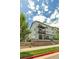 Three-story townhome showcases a modern design with a balcony and well-maintained landscaping at 2108 Alcott Way, Broomfield, CO 80023