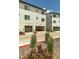 View of the townhome with two-car garage and light colored siding at 2108 Alcott Way, Broomfield, CO 80023