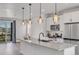 Well-lit kitchen with a large island, stainless appliances, and an open layout to the dining area at 2108 Alcott Way, Broomfield, CO 80023