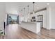 Spacious open-concept kitchen with island, stainless steel appliances and hardwood flooring at 2108 Alcott Way, Broomfield, CO 80023