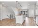 Bright kitchen features an island with bar seating, stainless appliances, and hardwood floors at 2108 Alcott Way, Broomfield, CO 80023