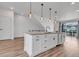 Stylish kitchen island with modern pendant lighting, white cabinets, and a sink with modern faucet at 2108 Alcott Way, Broomfield, CO 80023
