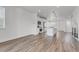 Open-concept kitchen with stainless steel appliances, sleek white cabinetry, and eat in island at 2108 Alcott Way, Broomfield, CO 80023