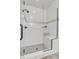 Contemporary shower features glass door, a built-in seat, and white subway tile with decorative accent at 2108 Alcott Way, Broomfield, CO 80023