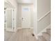 Entryway with white door, light wood floors and stairs at 8115 Mt Harvard Rd, Littleton, CO 80125