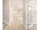 Light and bright hallway with light wood floors and carpet at 8115 Mt Harvard Rd, Littleton, CO 80125