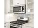 Stainless steel appliances and white shaker cabinets highlight this modern kitchen at 8115 Mt Harvard Rd, Littleton, CO 80125