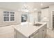 Open kitchen with island and stainless steel sink, looking toward living room at 8115 Mt Harvard Rd, Littleton, CO 80125