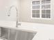 Stainless steel sink with modern chrome faucet in a bright kitchen at 8115 Mt Harvard Rd, Littleton, CO 80125