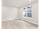 Spacious living room with light grey walls and wood-look flooring at 8115 Mt Harvard Rd, Littleton, CO 80125