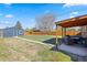 Large backyard offering a covered patio, detached garage, and space for outdoor activities at 3011 Oneida St, Denver, CO 80207