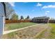 Backyard with grass area and view of the house, fence, garage, and patio at 3011 Oneida St, Denver, CO 80207