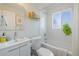 Clean, bright bathroom with a shower-tub, white tile, and a vanity at 3011 Oneida St, Denver, CO 80207