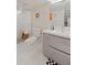 Clean bathroom featuring a tiled walk-in shower, floating vanity, and checkerboard rug at 3011 Oneida St, Denver, CO 80207