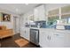 A bright kitchen featuring stainless steel appliances, a window view, and updated cabinets at 3011 Oneida St, Denver, CO 80207