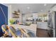 Bright kitchen featuring stainless steel appliances, an island cooktop, and stylish bar seating at 3011 Oneida St, Denver, CO 80207