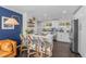 Modern kitchen featuring stainless steel appliances, white cabinets, and stylish counter seating at 3011 Oneida St, Denver, CO 80207