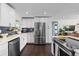 Spacious kitchen with stainless steel appliances, white cabinetry, and an open layout at 3011 Oneida St, Denver, CO 80207
