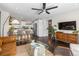 Bright and airy living room featuring an open layout to the kitchen, modern ceiling fan, and hardwood floors at 3011 Oneida St, Denver, CO 80207