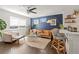 Cozy living room featuring modern furnishings, dark hardwood floors, and natural light at 3011 Oneida St, Denver, CO 80207