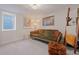 Cozy living room with comfortable green sofa and patterned ottoman at 3011 Oneida St, Denver, CO 80207
